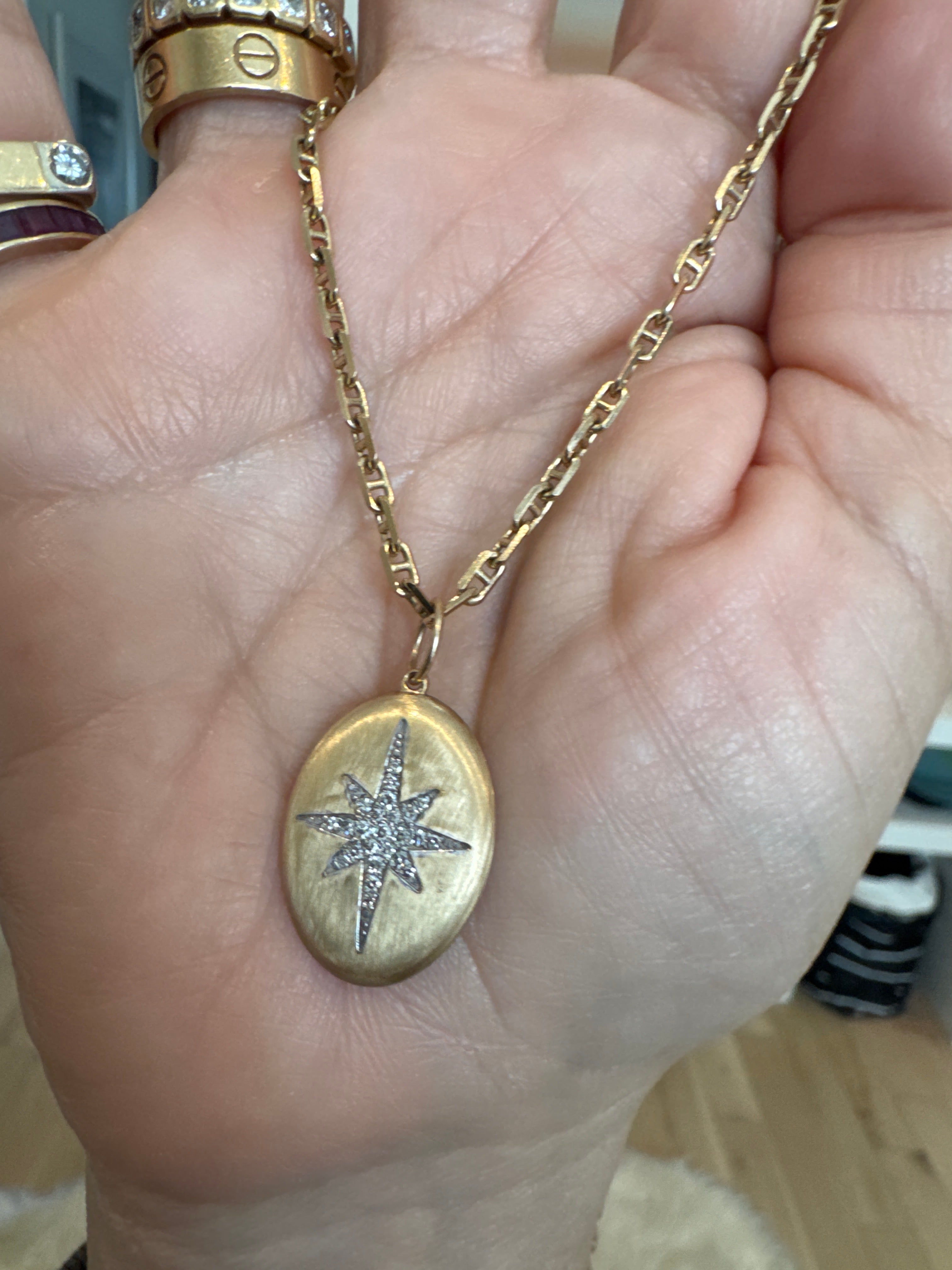 Brushed oval starburst pendant